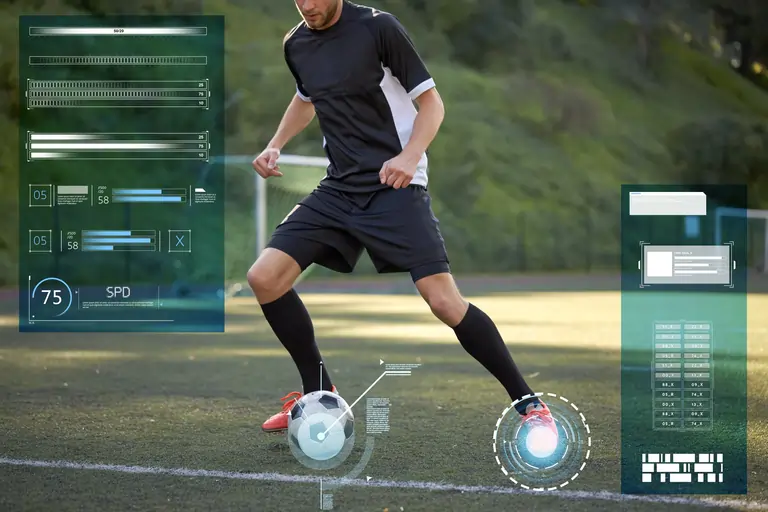 Sportman playing football in front of technology hud interface